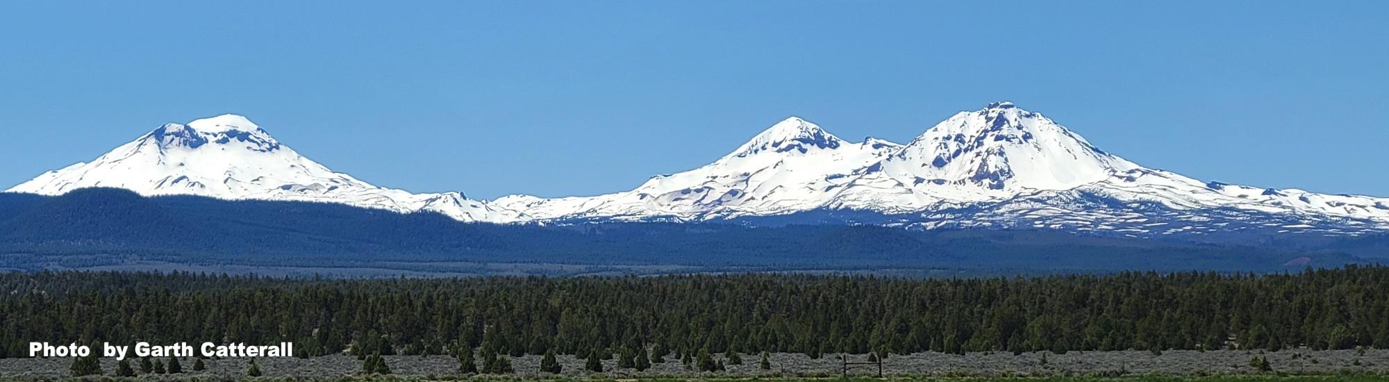 Snowy Sisters Mountains by Garth Catterall